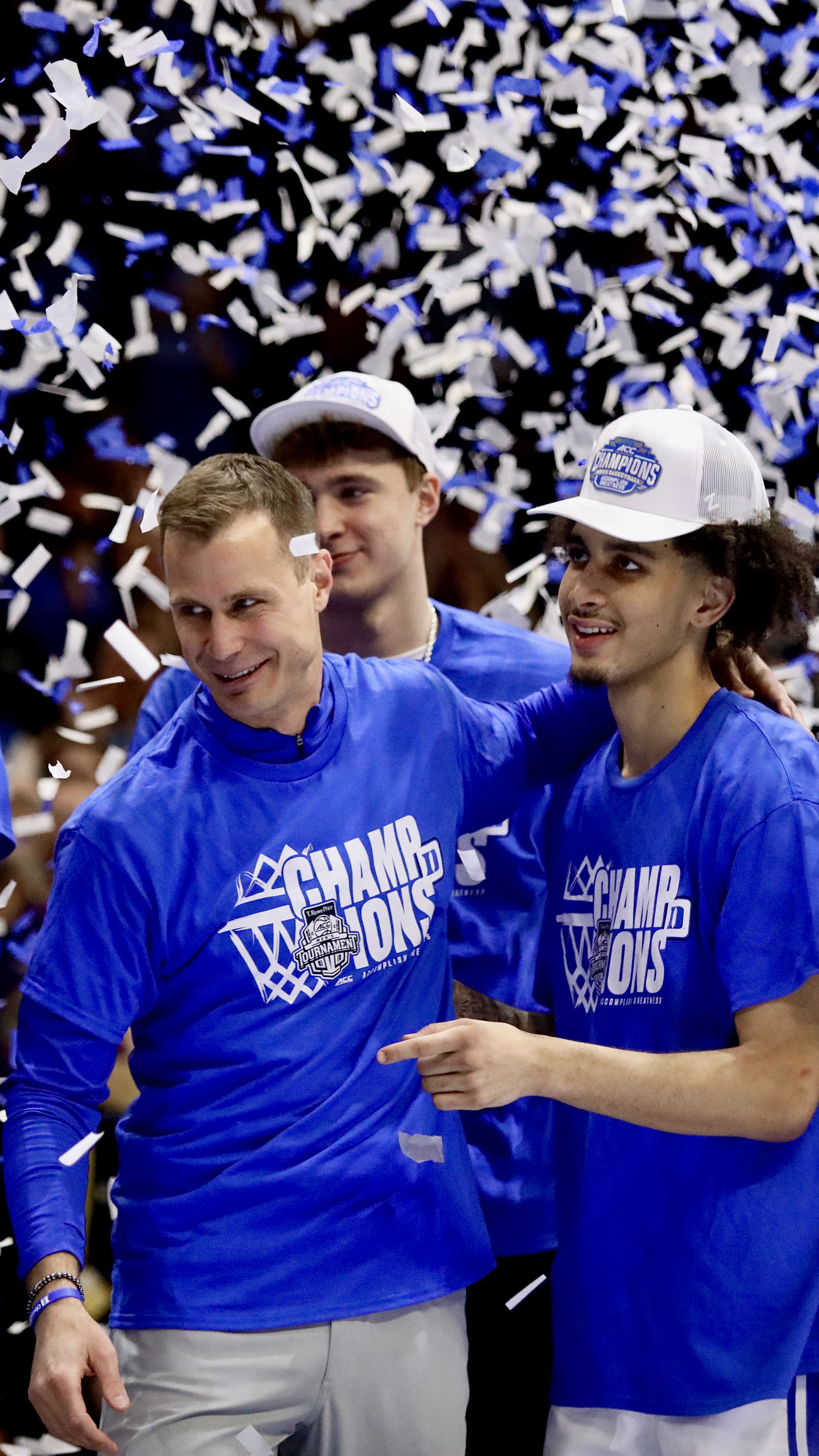 duke basketball head coach jon scheyer and player tyrese proctor celebrating 2025 ACC tournament win